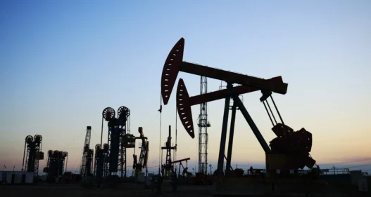 In the evening, the outline of the oil pump - stock photo
