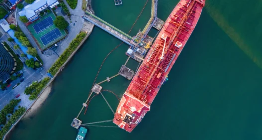 Aerial view Oil ship tanker to loading dock for load or unload oil to refinery on the sea. - stock photo