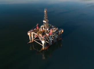 Oil exploration platform in a sea channel photographed by drone, Cromarty Firth, Scotland, United Kingdom - stock photo