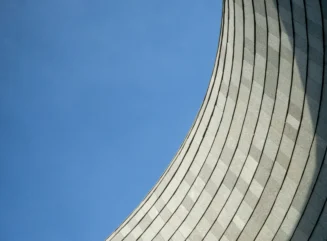 Curved Concrete Structure against Blue Sky - stock photo
