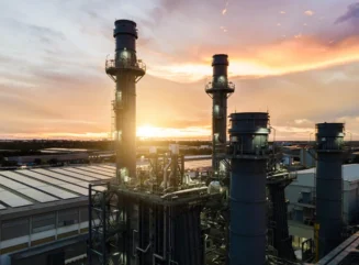 Gas turbine electrical power plant during sunset with solar panels - stock photo